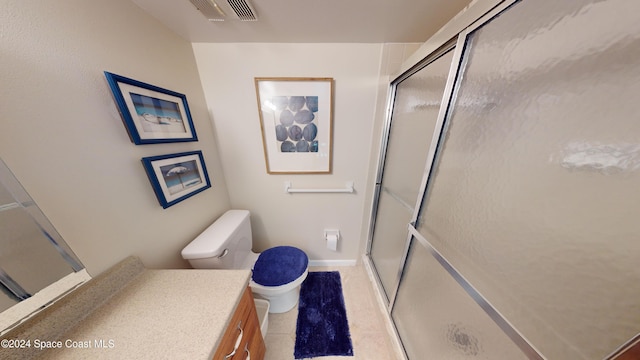 bathroom featuring walk in shower, vanity, tile patterned floors, and toilet