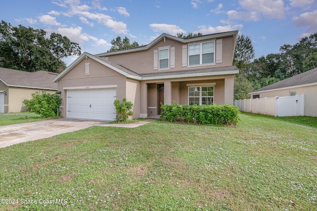 front facade with a garage and a front lawn