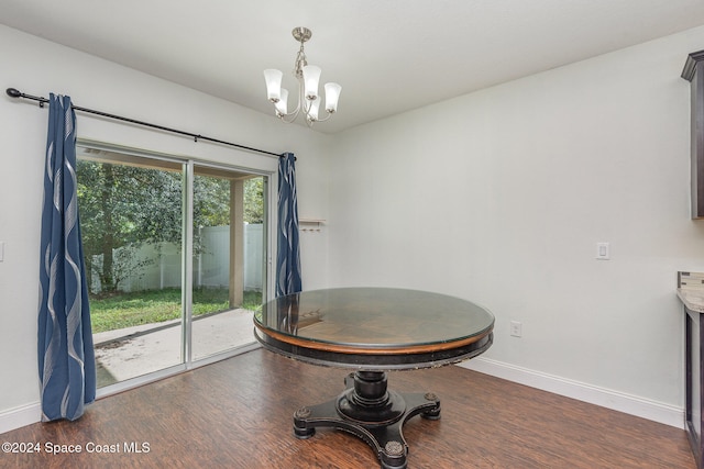 dining room featuring an inviting chandelier and dark hardwood / wood-style floors