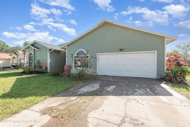 view of front of property featuring a garage and a front lawn