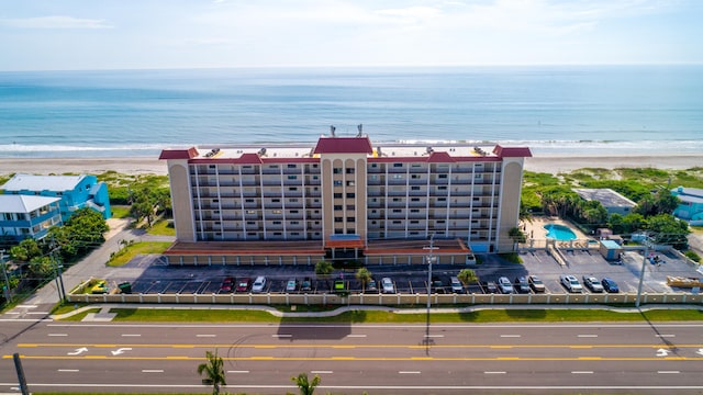 drone / aerial view featuring a view of the beach and a water view