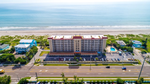 birds eye view of property with a view of the beach and a water view