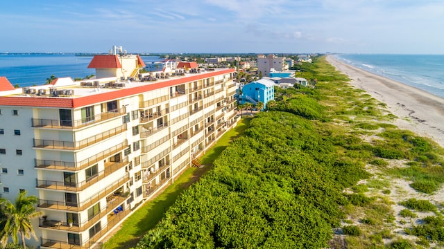 drone / aerial view featuring a beach view and a water view