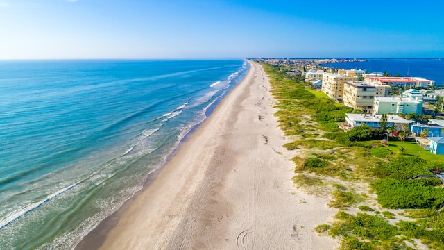 bird's eye view with a water view and a view of the beach