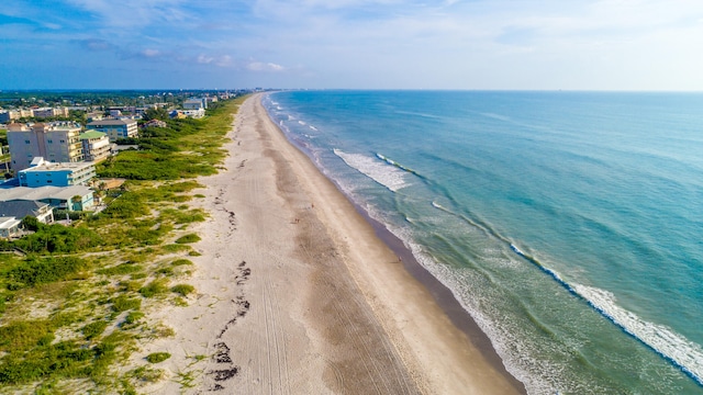 drone / aerial view featuring a beach view and a water view