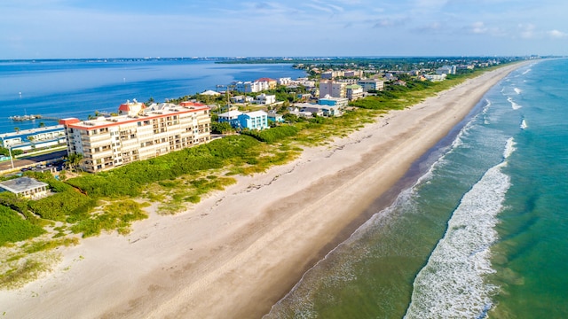 birds eye view of property with a beach view and a water view