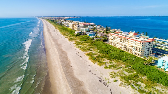 bird's eye view featuring a water view and a beach view