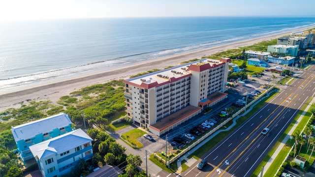 birds eye view of property with a beach view and a water view