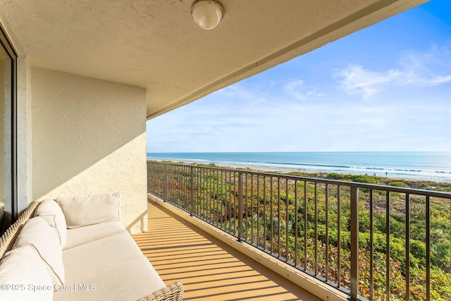 balcony with a beach view and a water view