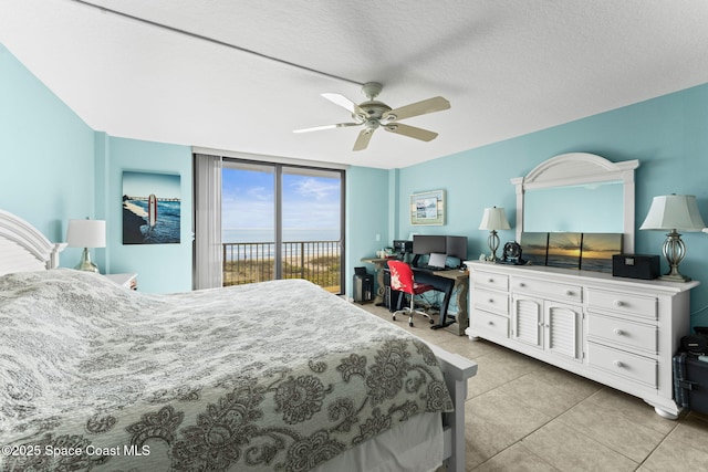 bedroom with a textured ceiling, access to outside, light tile patterned floors, and ceiling fan