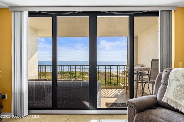 doorway featuring a wealth of natural light, a water view, and tile patterned flooring