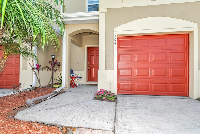 doorway to property with a garage