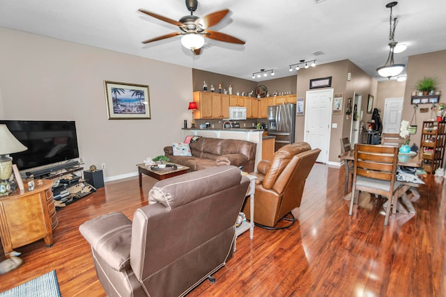 living room with ceiling fan and light hardwood / wood-style flooring