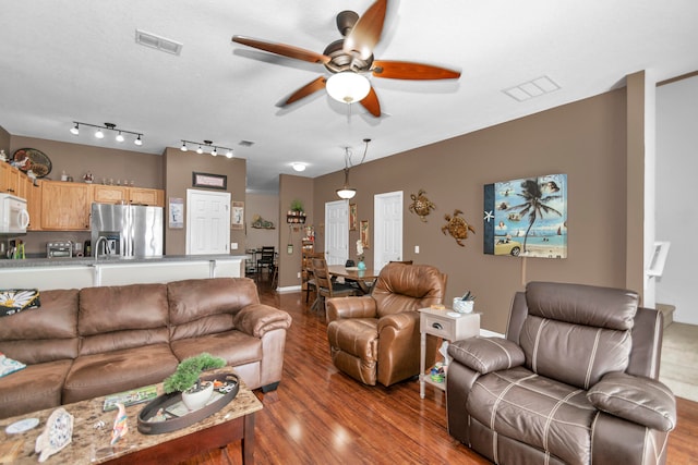 living room with light hardwood / wood-style floors, ceiling fan, and sink