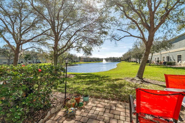 view of yard featuring a water view and a patio area