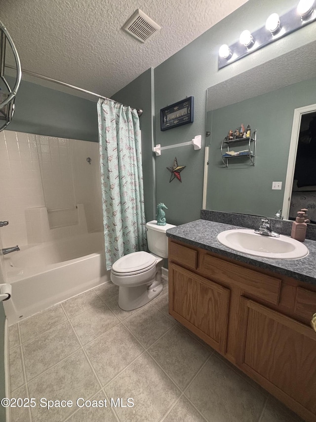 2650 Revolution St Unit 104, Melbourne, FL 32935 - bathroom with toilet, vanity, tile patterned flooring, shower / bath combo, and a textured ceiling