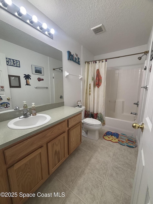 2650 Revolution St Unit 104, Melbourne, FL 32935 - full bath featuring toilet, vanity, shower / bath combo with shower curtain, tile patterned flooring, and a textured ceiling