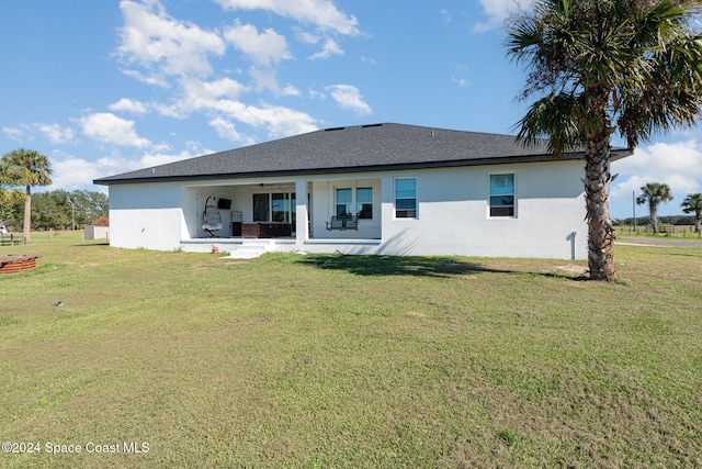 rear view of house featuring a patio, ceiling fan, and a lawn