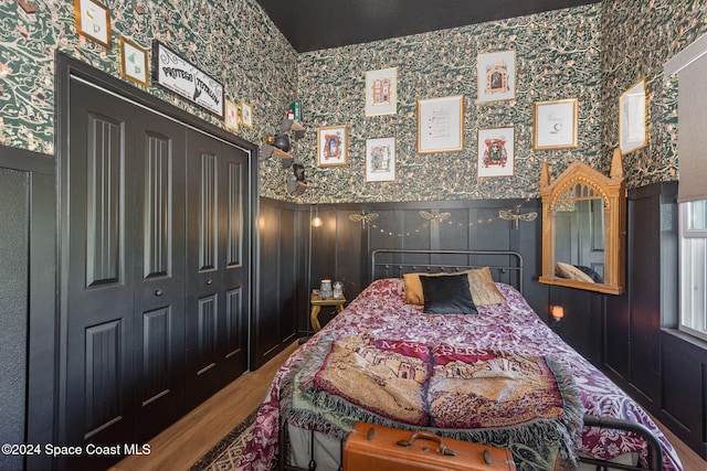 bedroom with wood-type flooring and a closet