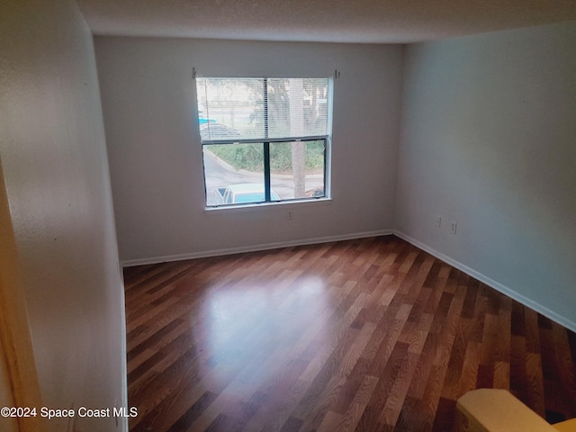 empty room with dark hardwood / wood-style floors