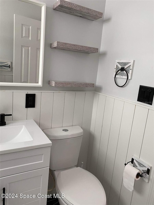 bathroom featuring toilet and vanity