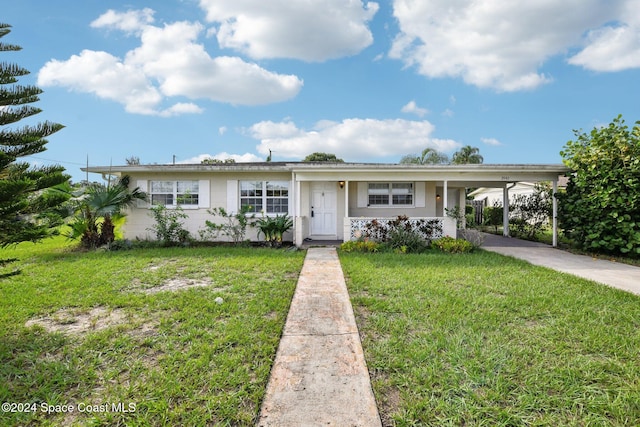 ranch-style home featuring a front yard and a carport