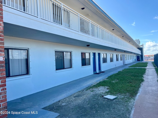 view of side of home with a balcony