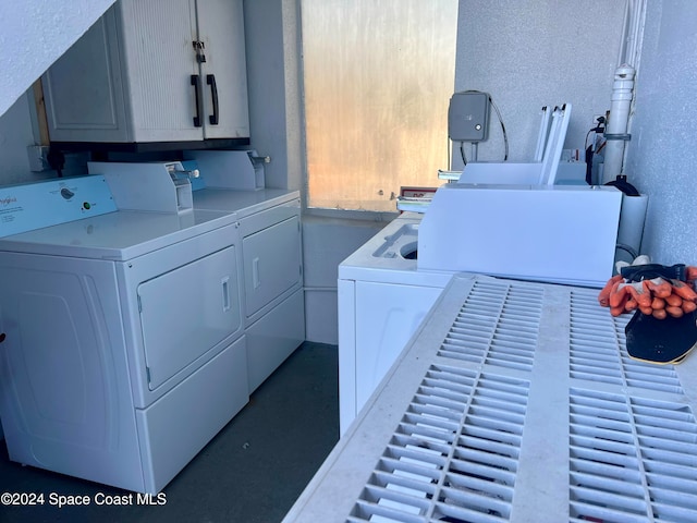 laundry room featuring cabinets and washer and dryer