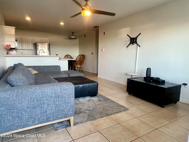 living room featuring light tile patterned flooring and ceiling fan