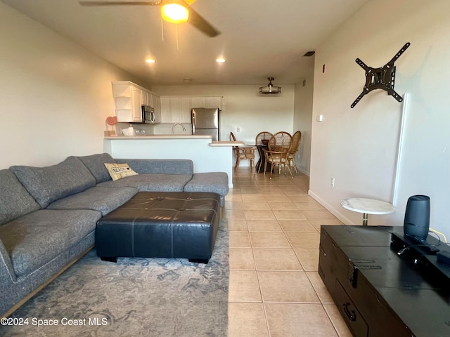 tiled living room with ceiling fan