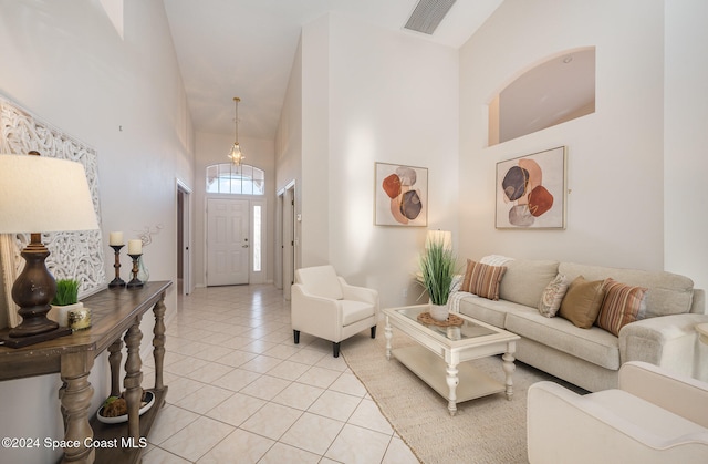 tiled living room with high vaulted ceiling