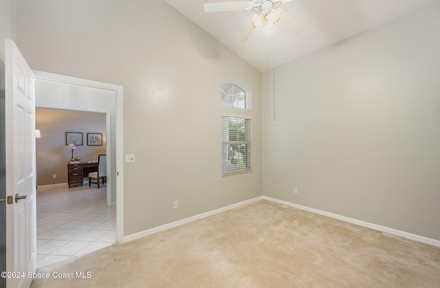 carpeted empty room featuring ceiling fan and high vaulted ceiling