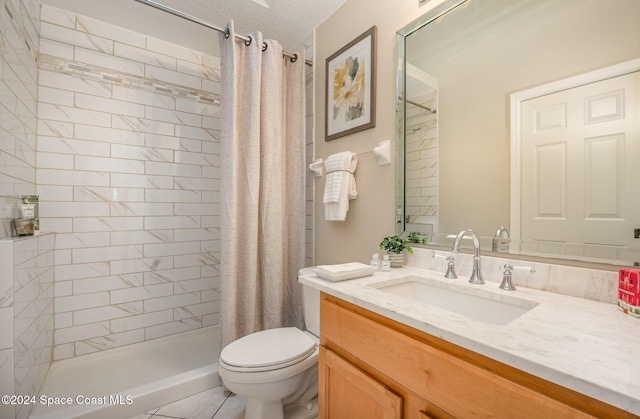 bathroom with vanity, tile patterned flooring, toilet, walk in shower, and a textured ceiling