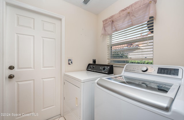 laundry area with independent washer and dryer