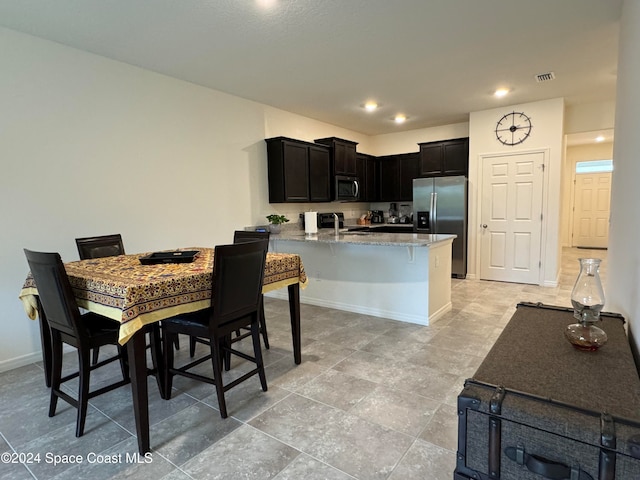 kitchen with stainless steel appliances and light stone countertops