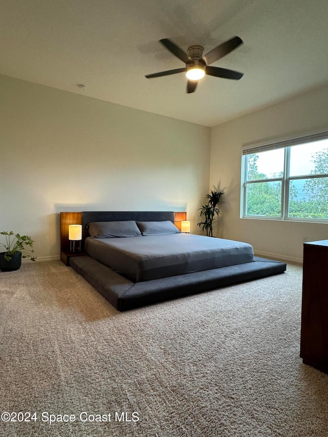 unfurnished bedroom with ceiling fan and carpet floors