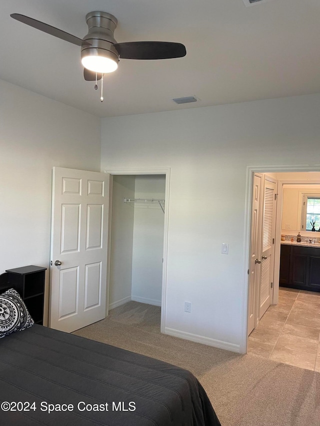 carpeted bedroom with a closet and ceiling fan