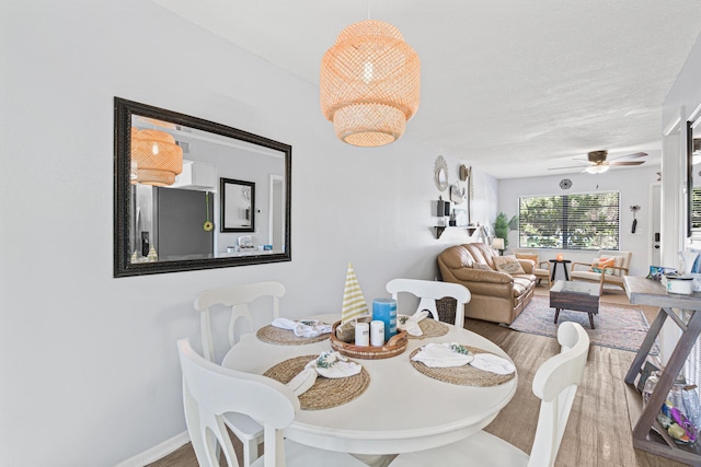 dining area featuring hardwood / wood-style floors and ceiling fan