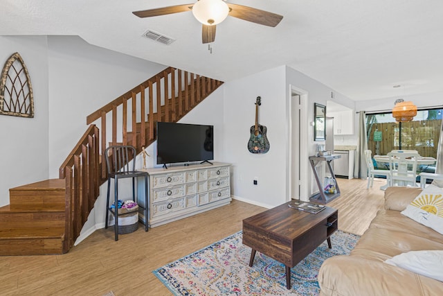 living room featuring ceiling fan and light wood-type flooring