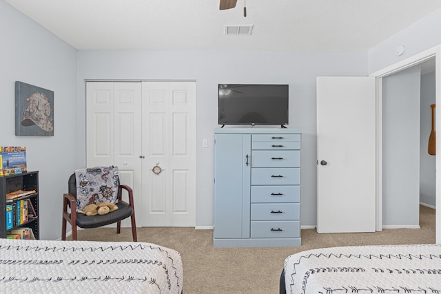 carpeted bedroom with a closet and ceiling fan