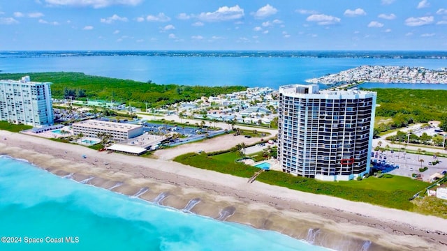 drone / aerial view with a water view and a beach view