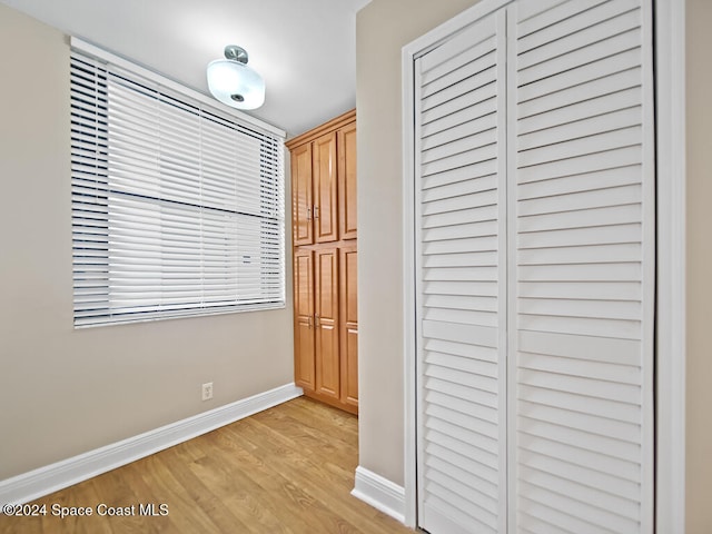 hallway with light hardwood / wood-style floors