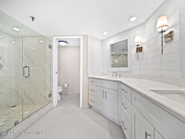 bathroom featuring walk in shower, vanity, and toilet