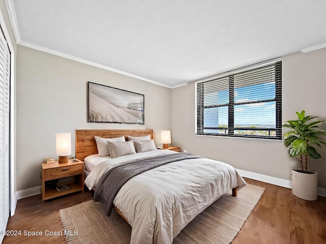 bedroom featuring hardwood / wood-style floors and ornamental molding