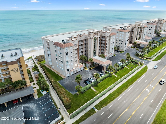 birds eye view of property with a view of the beach and a water view