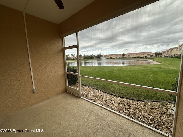 unfurnished sunroom featuring a water view