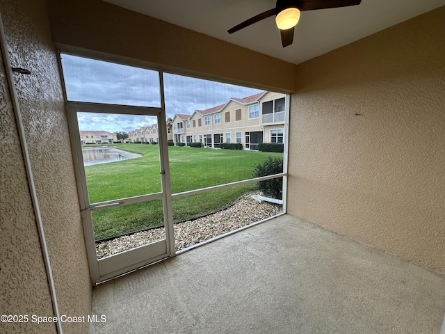 unfurnished sunroom featuring ceiling fan