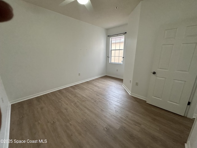 unfurnished room with ceiling fan and dark wood-type flooring