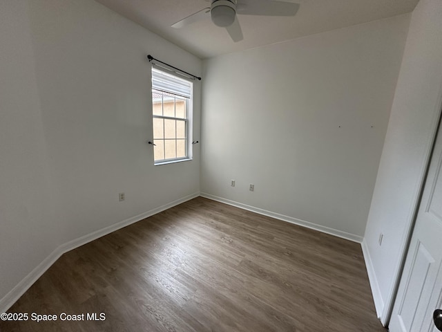 spare room featuring ceiling fan and dark hardwood / wood-style flooring