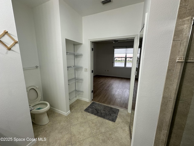 bathroom with tile patterned floors and toilet